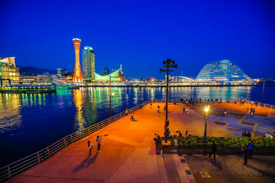 Kobe harbor promenade at twilight with Port Tower and city lights