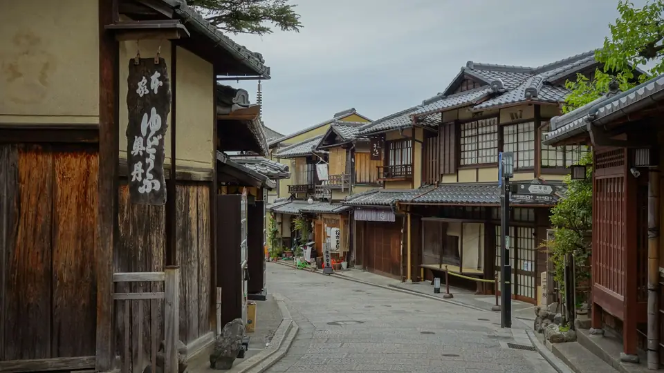 A quiet street of wooden townhouses in the early morning
